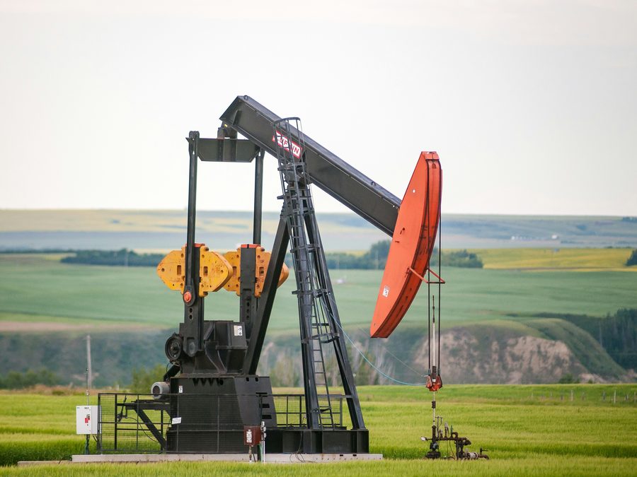 Pumpjack on open ground with a service meter and disconnect at the wellhead, oilfield electrical and motor control work
